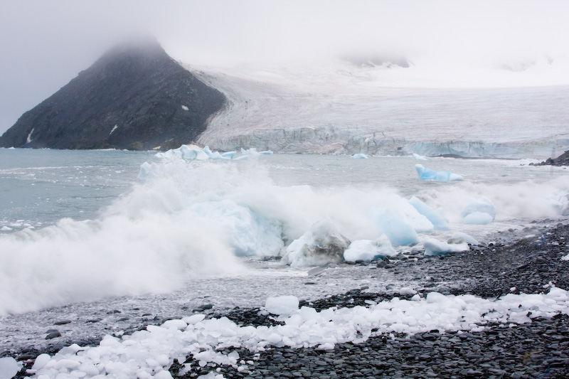 Waves Breaking Over Grounded Icebergs